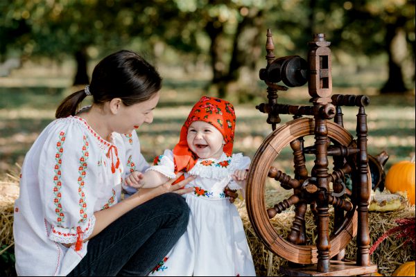 Mother and little daughter, having a moment by a spindel