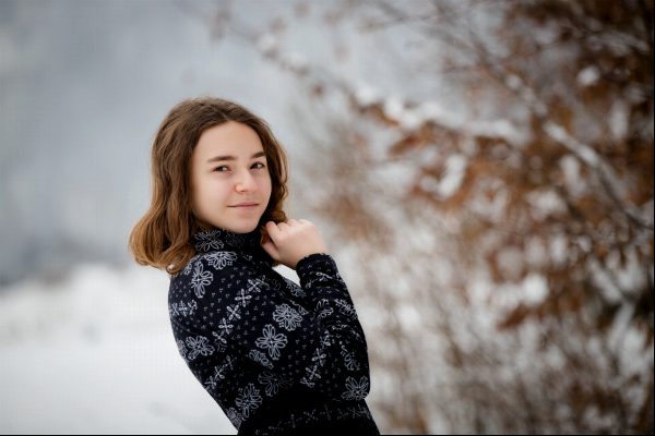 Girl posing on the winter background