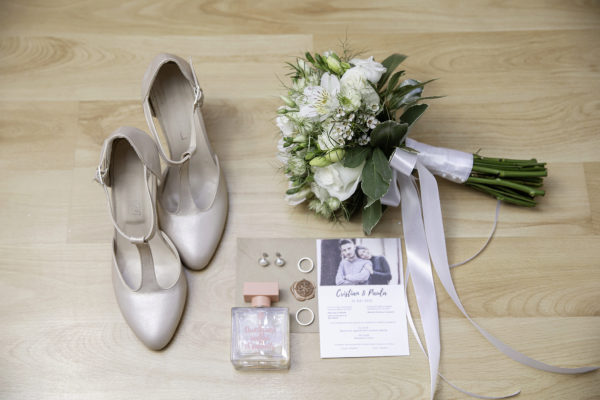 Hochzeitsschuhe, Hochzeitsstrauß, Blumenstrauß, Hochzeitseinladungen und Trauringe.